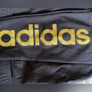 Adidas goes down the side leg it’s gold with bling on it cozy love them  SIZE L
